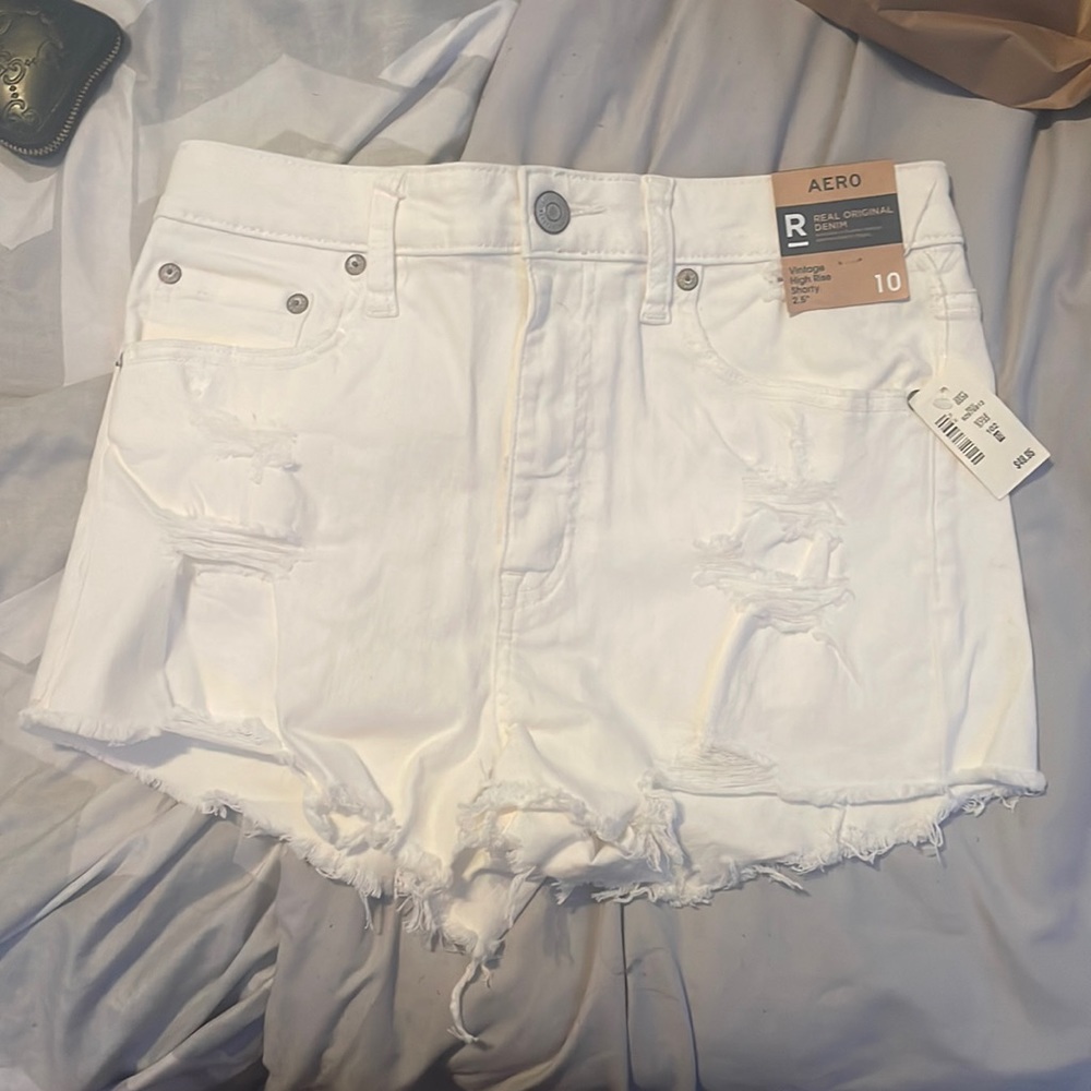 White ripped denim shorts